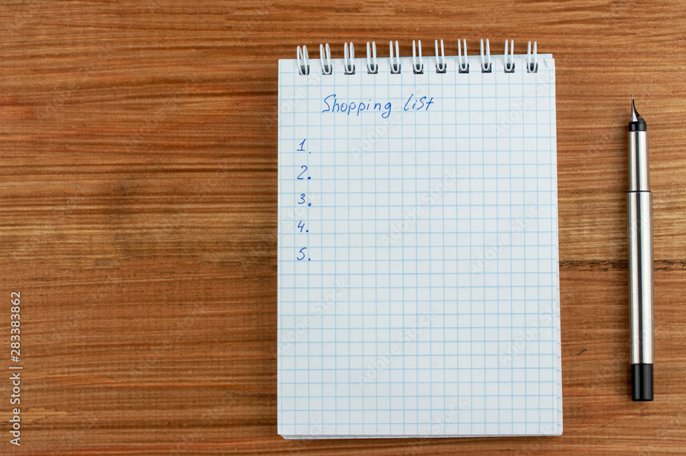 shopping list on wooden background shopping list on wooden background
