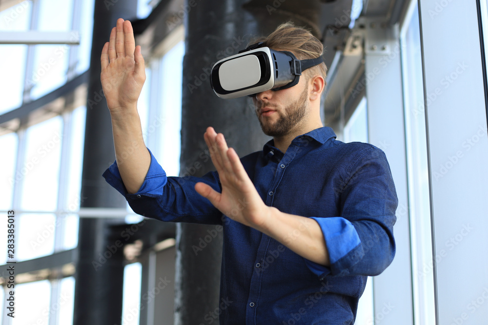 Shot of an engineer wearing a VR headset in an new building. Change the way you see and experience the world. Shot of an engineer wearing a VR headset in an new building. Change the way you see and experience the world.