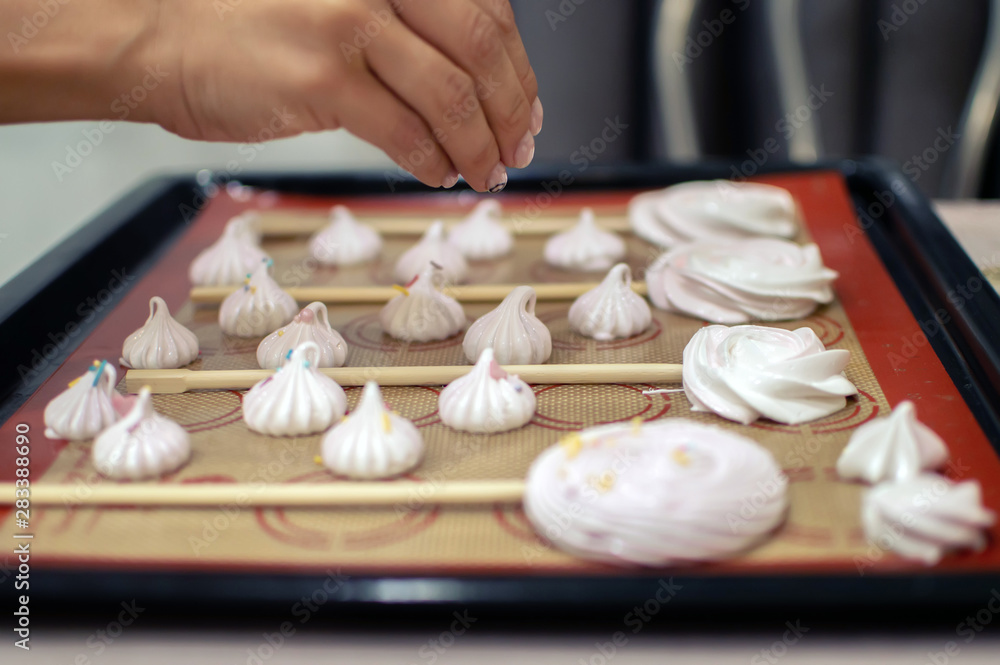 the girl's hands prepare the meringue at home. confectionery. selective focus