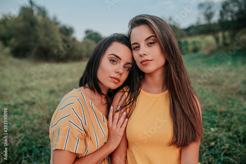 Portrait of two young girls enjoying in the nature