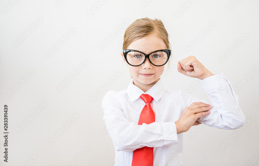 Portrait of a strong girl showing the muscles of his arms on white background