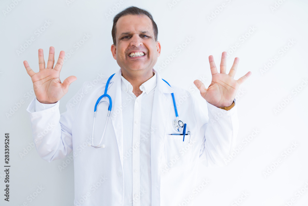 Middle age doctor man wearing stethoscope and medical coat over white background showing and pointing up with fingers number ten while smiling confident and happy. Middle age doctor man wearing stethoscope and medical coat over white background showing and pointing up with fingers number ten while smiling confident and happy.