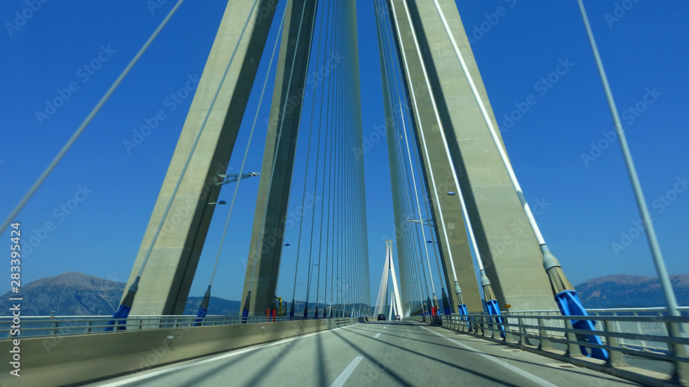 Naklejka premium Driving through famous modern anti seismic cable bridge of Rio Antirio Harilaos Trikoupis that connects Peloponnese to mainland Greece