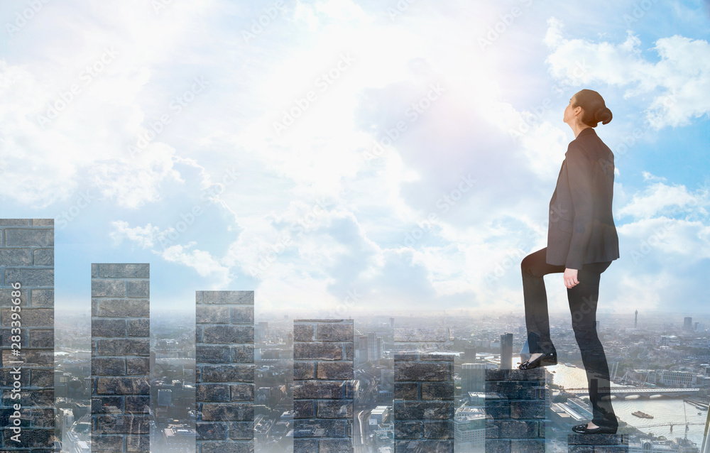 Young woman climbing up on the growth bars and looking positive to the future. Blue sky and sunshine. Business, success and strategy concept Young woman climbing up on the growth bars and looking positive to the future. Blue sky and sunshine. Business, success and strategy concept