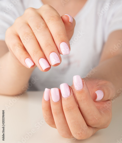 female hand with light pink nail design....