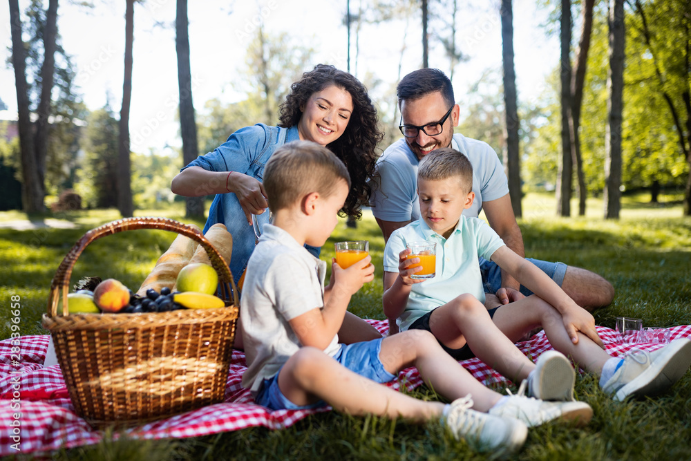 Fototapeta premium Cheerful happy family picnicking on a beautiful day