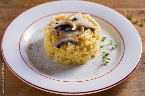 Healthy vegetarian dish: couscous with creamy mushroom sauce. Couscous with topping
