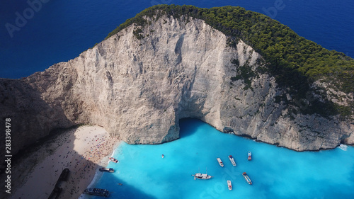 Aerial drone panoramic breathtaking view of iconic beach of Navagio or Shipwreck with deep turquoise clear sea and beautiful clouds, Zakynthos island, Ionian, Greece