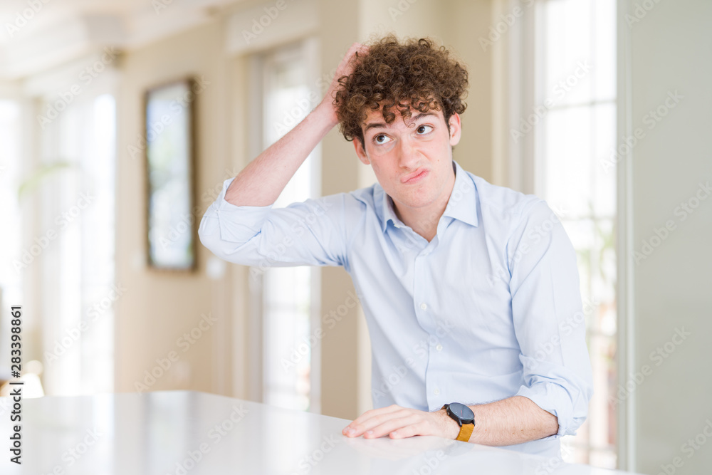 Young business man with curly read head confuse and wondering about question. Uncertain with doubt, thinking with hand on head. Pensive concept. Young business man with curly read head confuse and wondering about question. Uncertain with doubt, thinking with hand on head. Pensive concept.