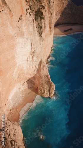 Fototapeta Naklejka Na Ścianę i Meble -  Aerial drone view of iconic beach of Navagio or Shipwreck voted one of the most beautiful beaches in the world with deep turquoise clear sea, Zakynthos island, Ionian, Greece