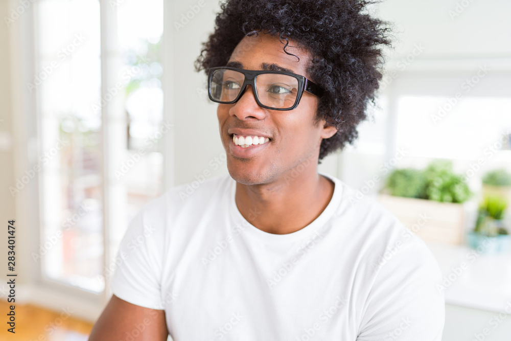 Fototapeta premium African American man wearing glasses smiling looking side and staring away thinking.