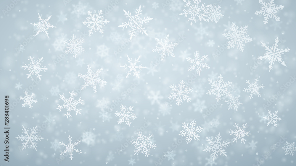 Christmas background of complex blurred and clear falling snowflakes in light blue colors with bokeh effect