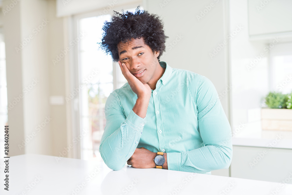 African American business man wearing elegant shirt thinking looking tired and bored with depression problems with crossed arms. African American business man wearing elegant shirt thinking looking tired and bored with depression problems with crossed arms.