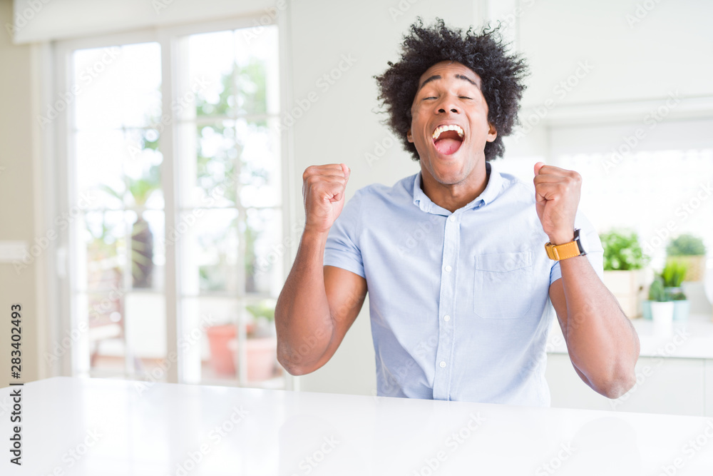 African American business man excited for success with arms raised celebrating victory smiling. Winner concept. African American business man excited for success with arms raised celebrating victory smiling. Winner concept.