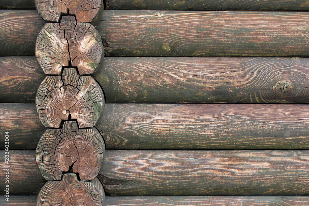 Part of wooden wall of structure build from wooden logs.. Part of wooden wall of structure build from wooden logs..