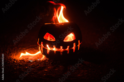 Obraz na plátně green watermelon burns with fiery flame on the scary holiday of october hallowee