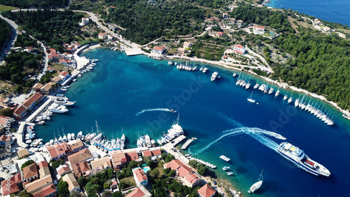 Aerial drone photo from picturesque and iconic port of Fiskardo with luxury boats docked and traditional character, Cefalonia island, Ionian, Greece