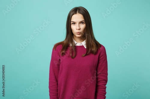Young brunette woman girl in casual clothes posing isolated on blue wall background studio portrait. People sincere emotions lifestyle concept. Mock up copy space. Looking camera blow send air kiss.
