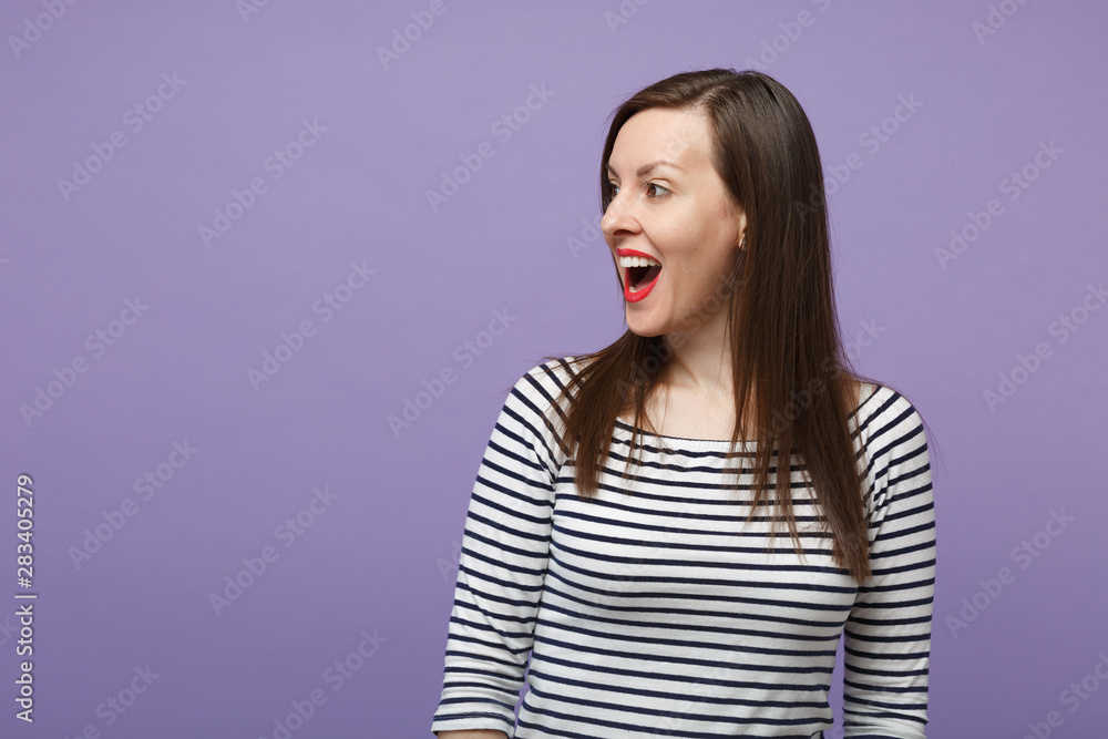 Young brunette woman girl in casual striped clothes posing isolated on violet purple wall background studio portrait. People sincere emotions lifestyle concept. Mock up copy space Looking aside smile. Young brunette woman girl in casual striped clothes posing isolated on violet purple wall background studio portrait. People sincere emotions lifestyle concept. Mock up copy space Looking aside smile.