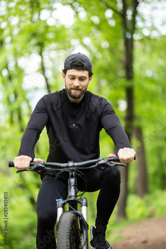 Mountain biker riding on bike in spring inspirational mountains landscape. Sport fitness motivation and inspiration. Rider mountain biking in fall woods. © F8  \ Suport Ukraine