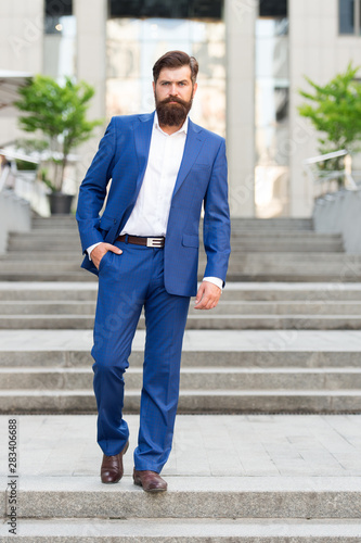Toward business achievements. Conquer business world. Office worker confidently step on stairs. Bearded man going to work. Business man in modern city. Beginning of working day. Motivated for success