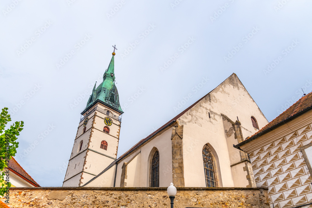 Fototapeta premium Spiky tower of Church of the Assumption of the Virgin Mary in Jindrichuv Hradec, Czech Republic