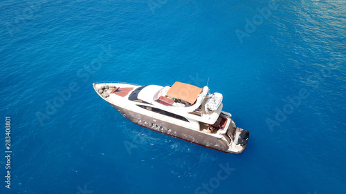 Aerial drone photo of large yacht - boat docked in tropical exotic paradise bay with emerald open ocean © aerial-drone
