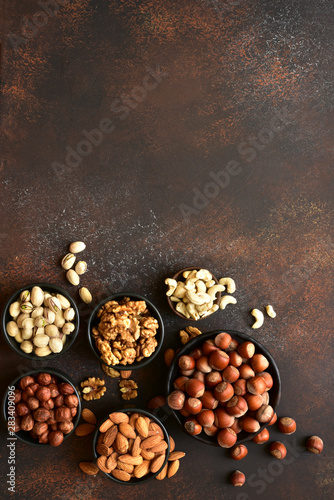 Assortment of nuts in a bowls - healthy snack.Top view with copy space .