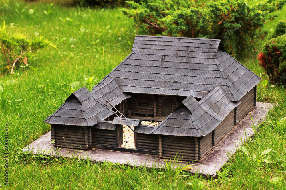 Miniature old wooden building in the garden