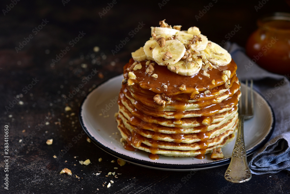 Homemade delicious banana pancakes with caramel sauce.