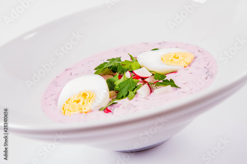 Cold borscht (chlodnik) - traditional Lithuanian cold soup with radish, parsley, dill and egg