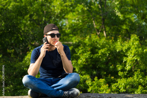 Young man with fear listens to the tirade on the phone