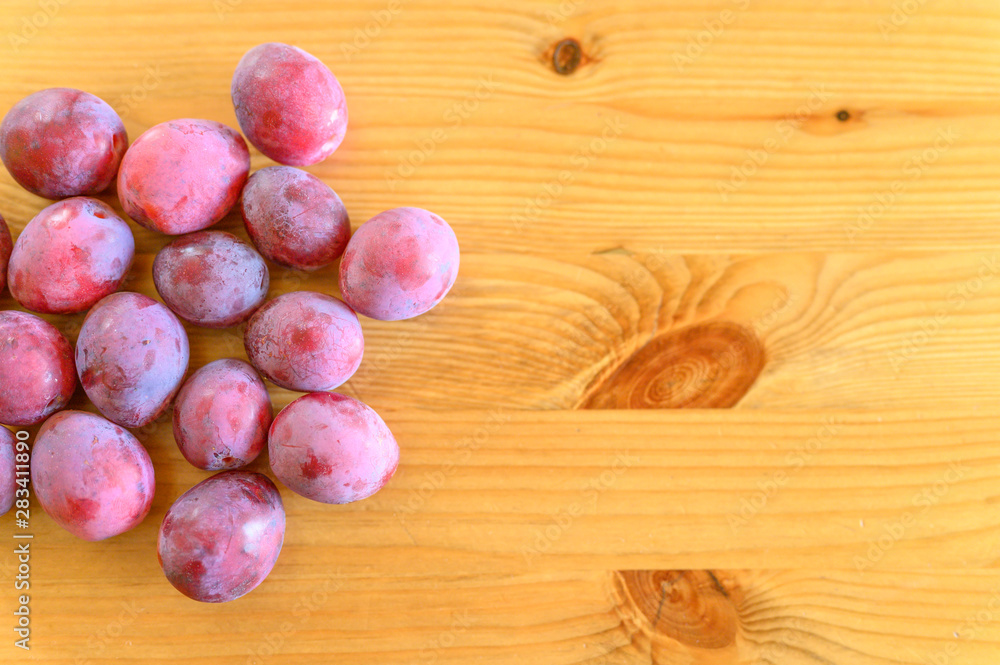 Several fresh ripe plums on wooden background Several fresh ripe plums on wooden background