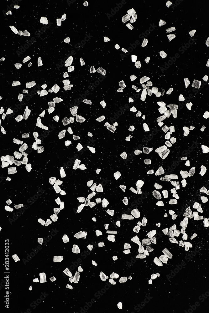 White salt on a black background.