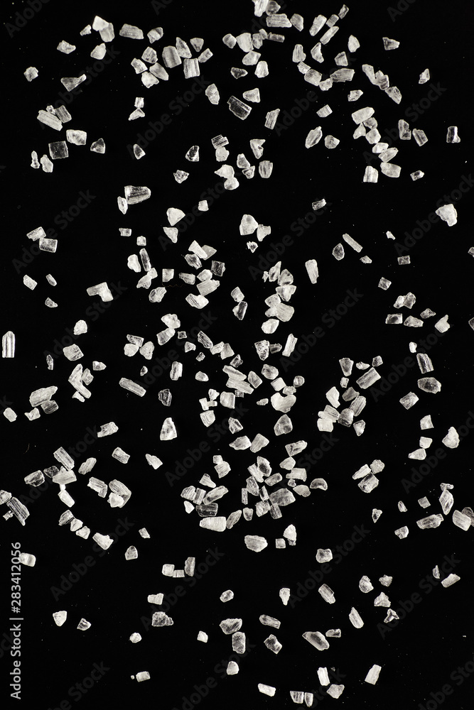 White salt on a black background. White salt on a black background.