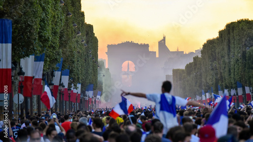 Fototapeta Naklejka Na Ścianę i Meble -  PARIS, France – July 15, 2018 : thousands of jubilant french fans on the Avenue des Champs-Élysées celebrating France's victory over Croatia in the 2018 FIFA World Cup Final.