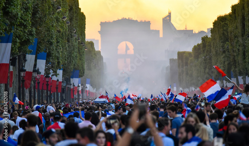 Fototapeta Naklejka Na Ścianę i Meble -  PARIS, France – July 15, 2018 : thousands of jubilant french fans on the Avenue des Champs-Élysées celebrating France's victory over Croatia in the 2018 FIFA World Cup Final.
