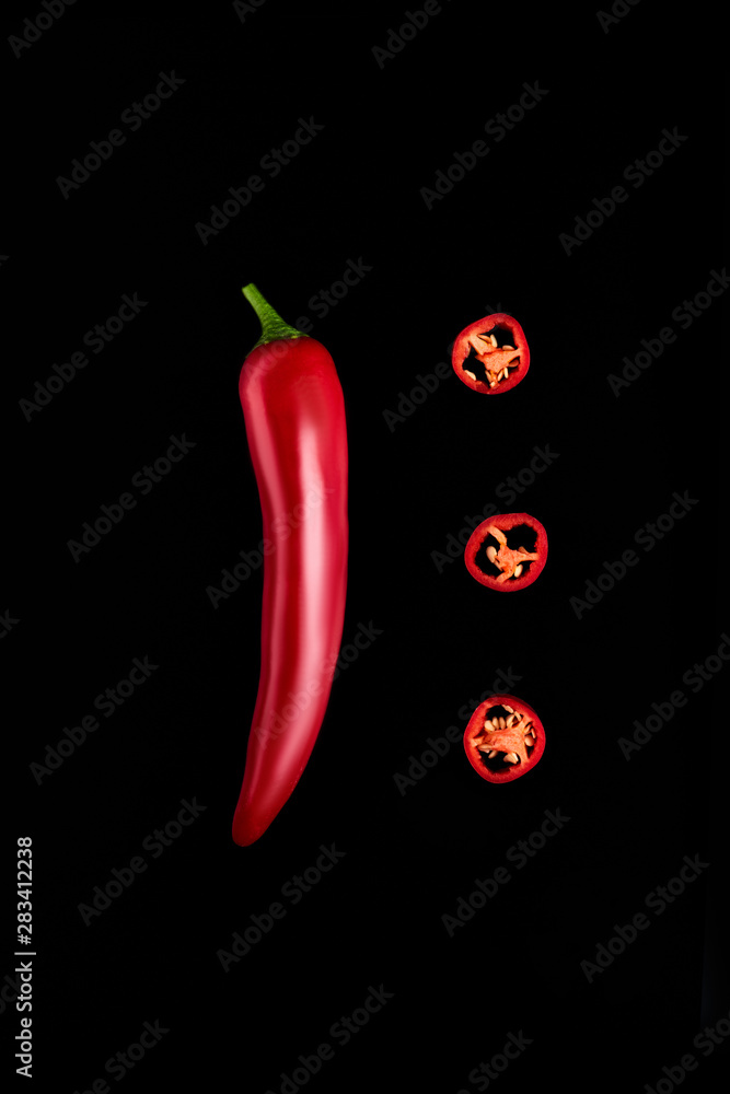 Seamless pattern with red hot chili peppers. Vegetables abstract background. Food collage, slicing hot red chili peppers Red hot chili peppers on a black background. Seamless pattern with red hot chili peppers. Vegetables abstract background. Food collage, slicing hot red chili peppers Red hot chili peppers on a black background.