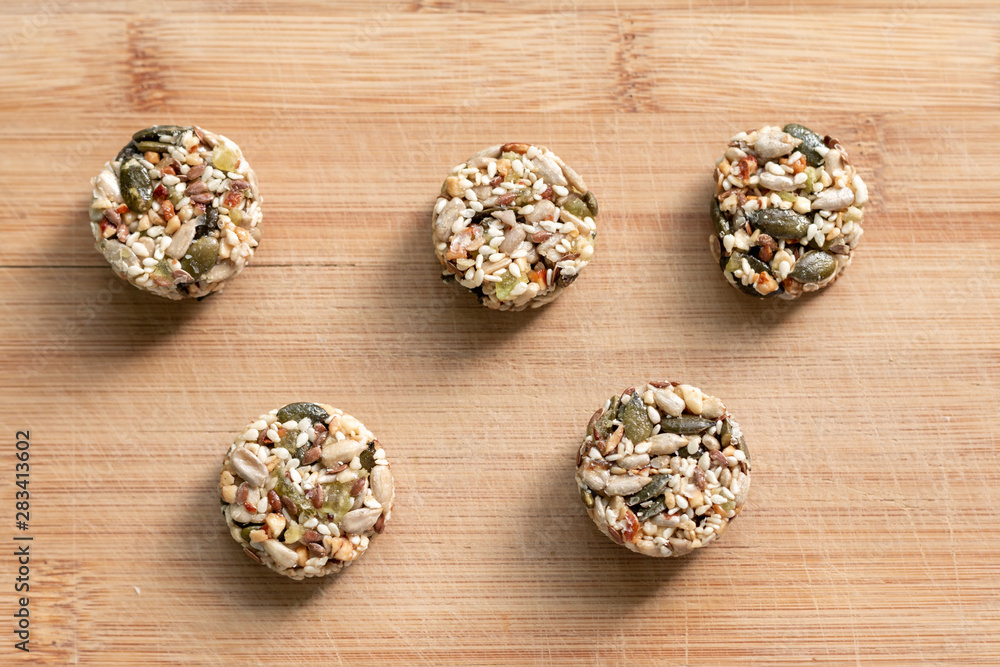 Homemade sweets energy balls made from superfoods like seeds, nuts and dried fruits. Healthy snack, raw dessert and superfood. With space for text Homemade sweets energy balls made from superfoods like seeds, nuts and dried fruits. Healthy snack, raw dessert and superfood. With space for text