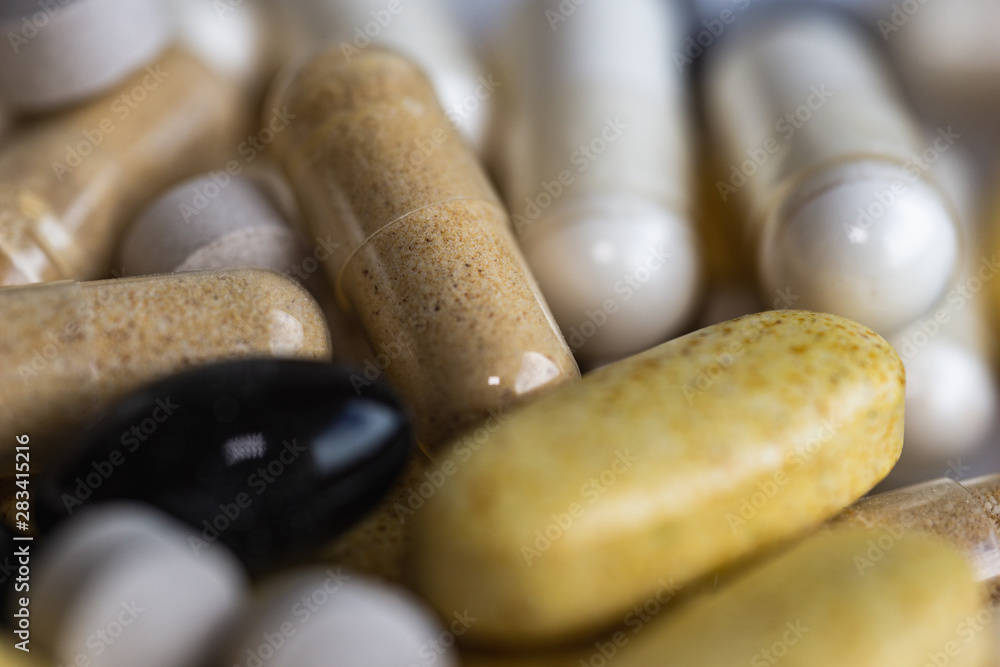 Piles of pills and capsule on white background. Selective focus Piles of pills and capsule on white background. Selective focus