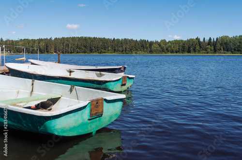 Boats on a lake pier near the forest