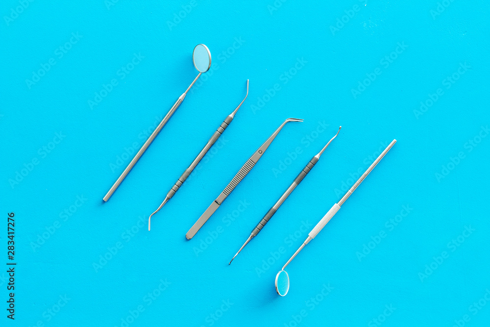 stomatologist instruments on blue doctor's office desk background top view stomatologist instruments on blue doctor's office desk background top view