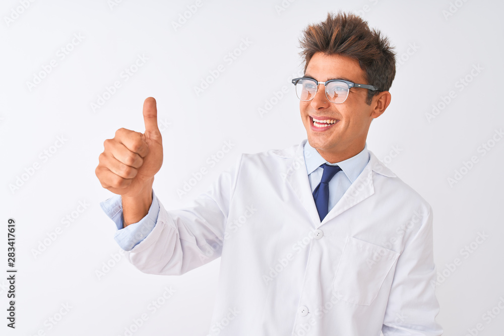 Young handsome sciencist man wearing glasses and coat over isolated white background Looking proud, smiling doing thumbs up gesture to the side Young handsome sciencist man wearing glasses and coat over isolated white background Looking proud, smiling doing thumbs up gesture to the side