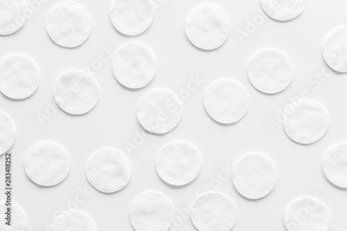 pattern of cosmetic cotton pads on white background top view