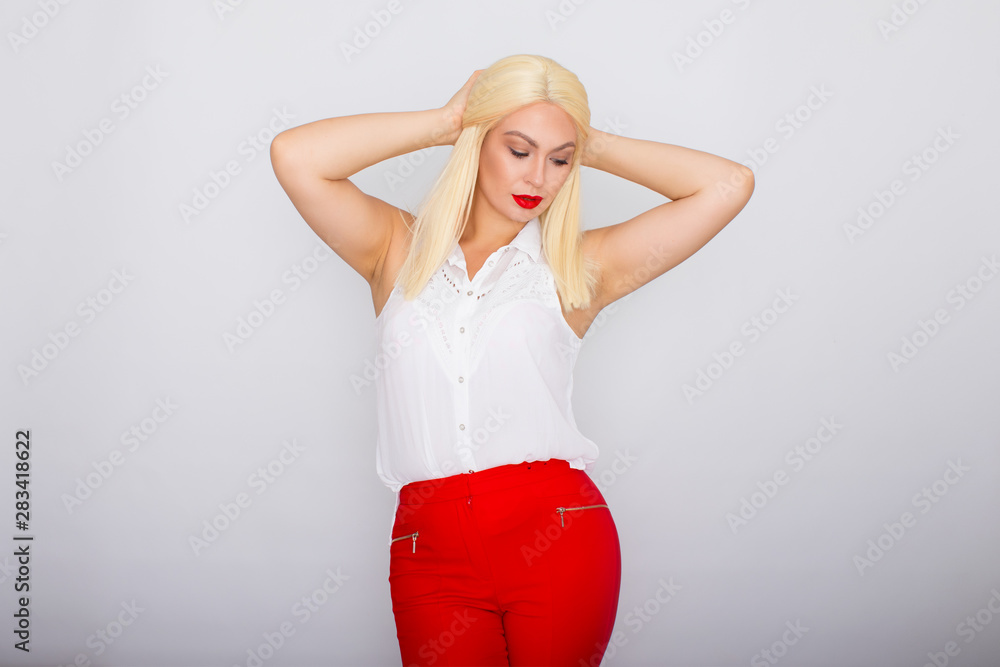 Photo of happy blond businesswoman with long hair smiling and posing Photo of happy blond businesswoman with long hair smiling and posing