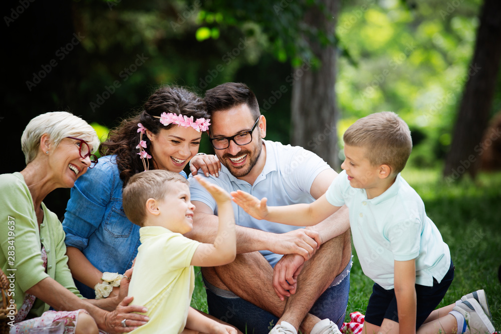 Happy family enjoying picnic in nature at summer Happy family enjoying picnic in nature at summer