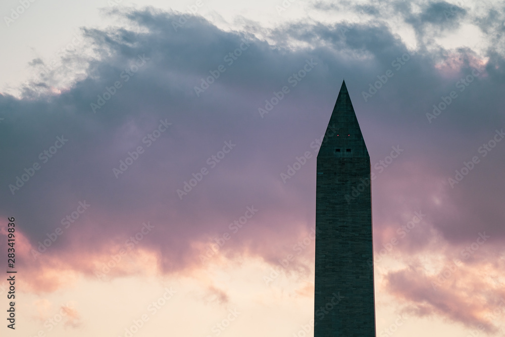 Washington Monument in DC United States with a colorful pastel summer sunset sky with clouds