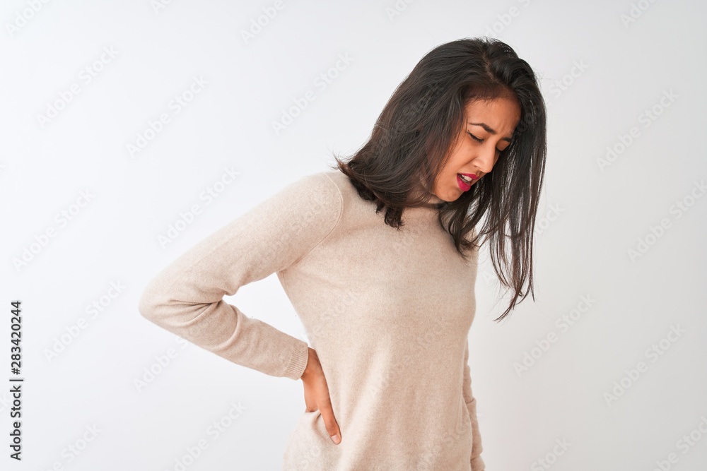 Beautiful chinese woman wearing turtleneck sweater standing over isolated white background Suffering of backache, touching back with hand, muscular pain Beautiful chinese woman wearing turtleneck sweater standing over isolated white background Suffering of backache, touching back with hand, muscular pain