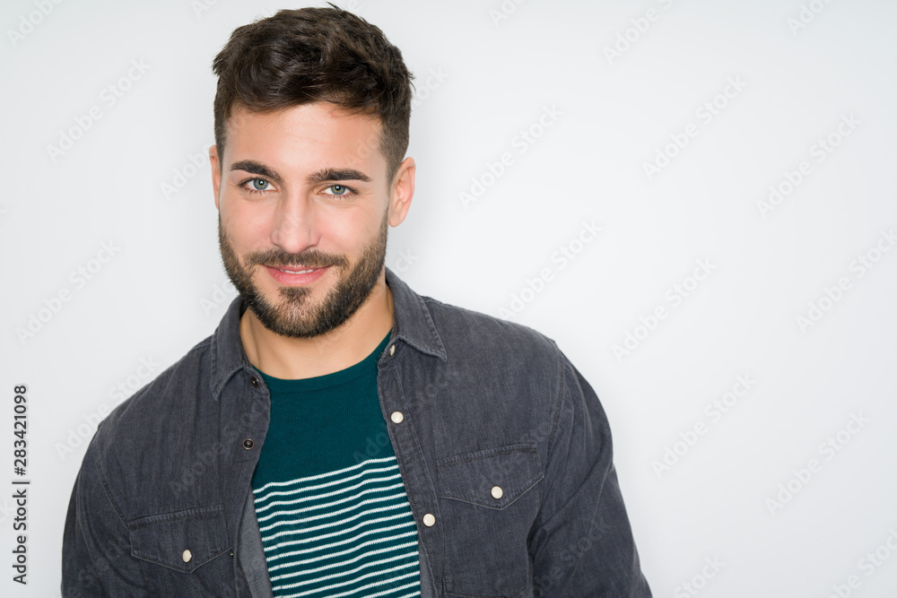 Young handsome man possing and modeling over grey isolated background Young handsome man possing and modeling over grey isolated background