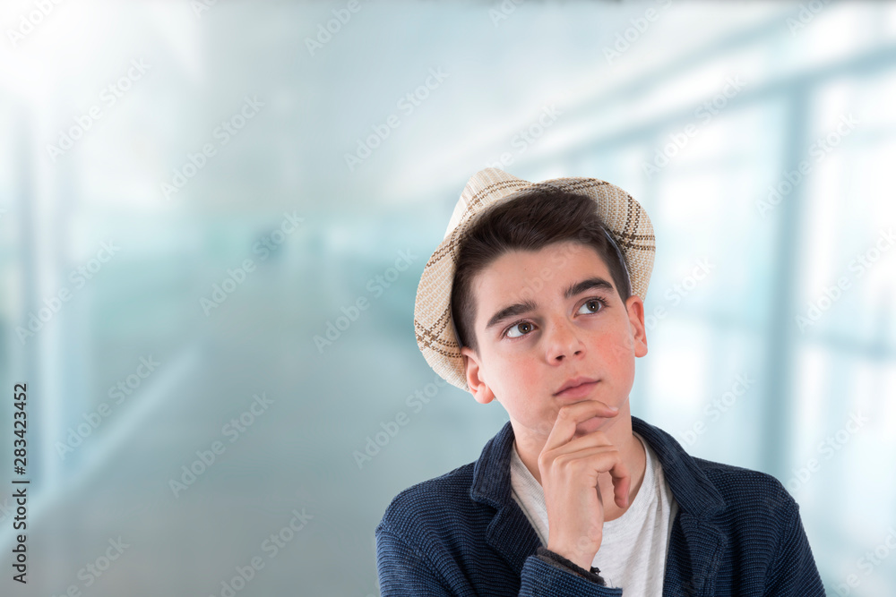 portrait of thoughtful boy in school or indoors portrait of thoughtful boy in school or indoors